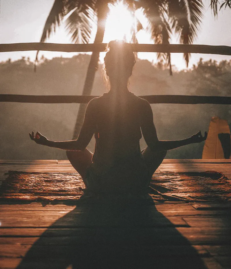 Person meditating outdoors for anxiety relief